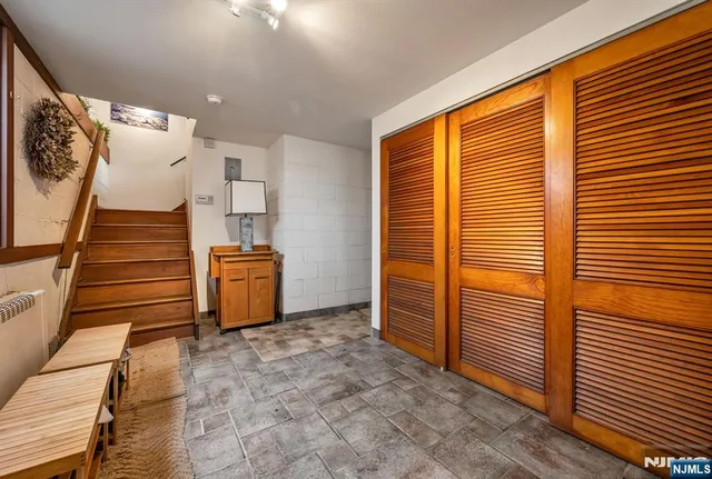 a view of a livingroom with furniture and stairs
