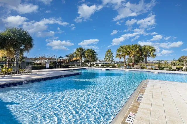 a view of swimming pool with outdoor seating and plants