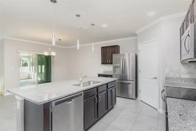 a kitchen with a sink appliances and cabinets