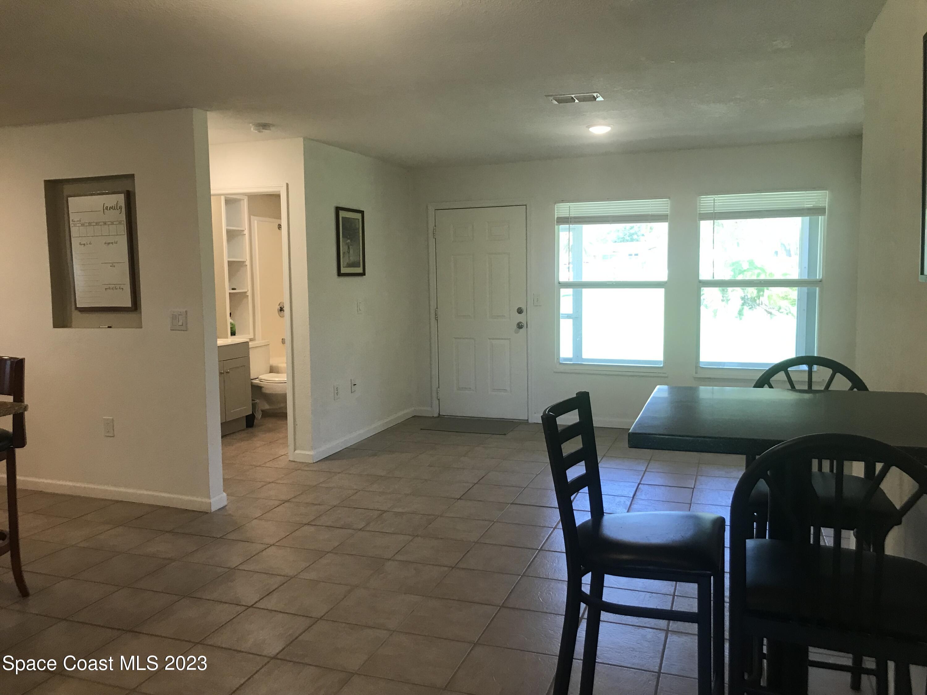 2525 Malabar Road Malabar, FL 32950 - Photo 11 of 30 a view of a dining room with furniture and window