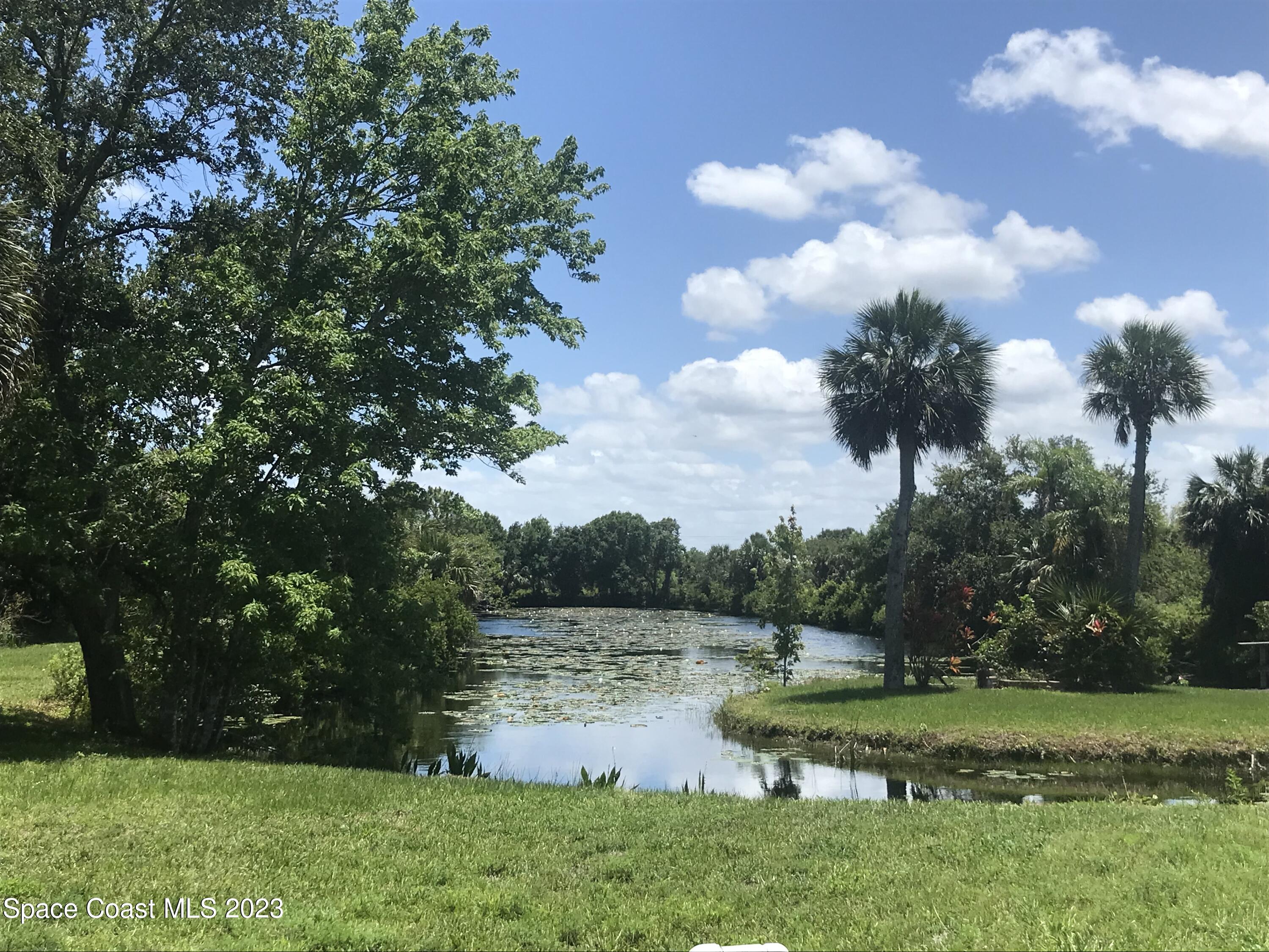 2525 Malabar Road Malabar, FL 32950 - Photo 23 of 30 a view of a lake with houses in the back