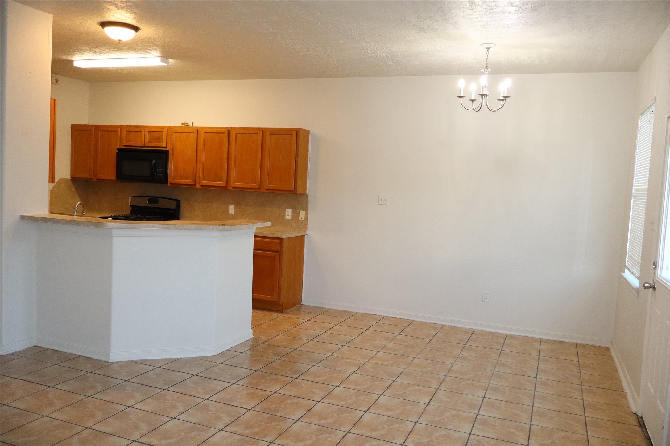 15931 Winston Point Lane Houston, TX 77084 - Photo 7 of 15 a kitchen with stainless steel appliances a sink a microwave a refrigerator and a counter top space