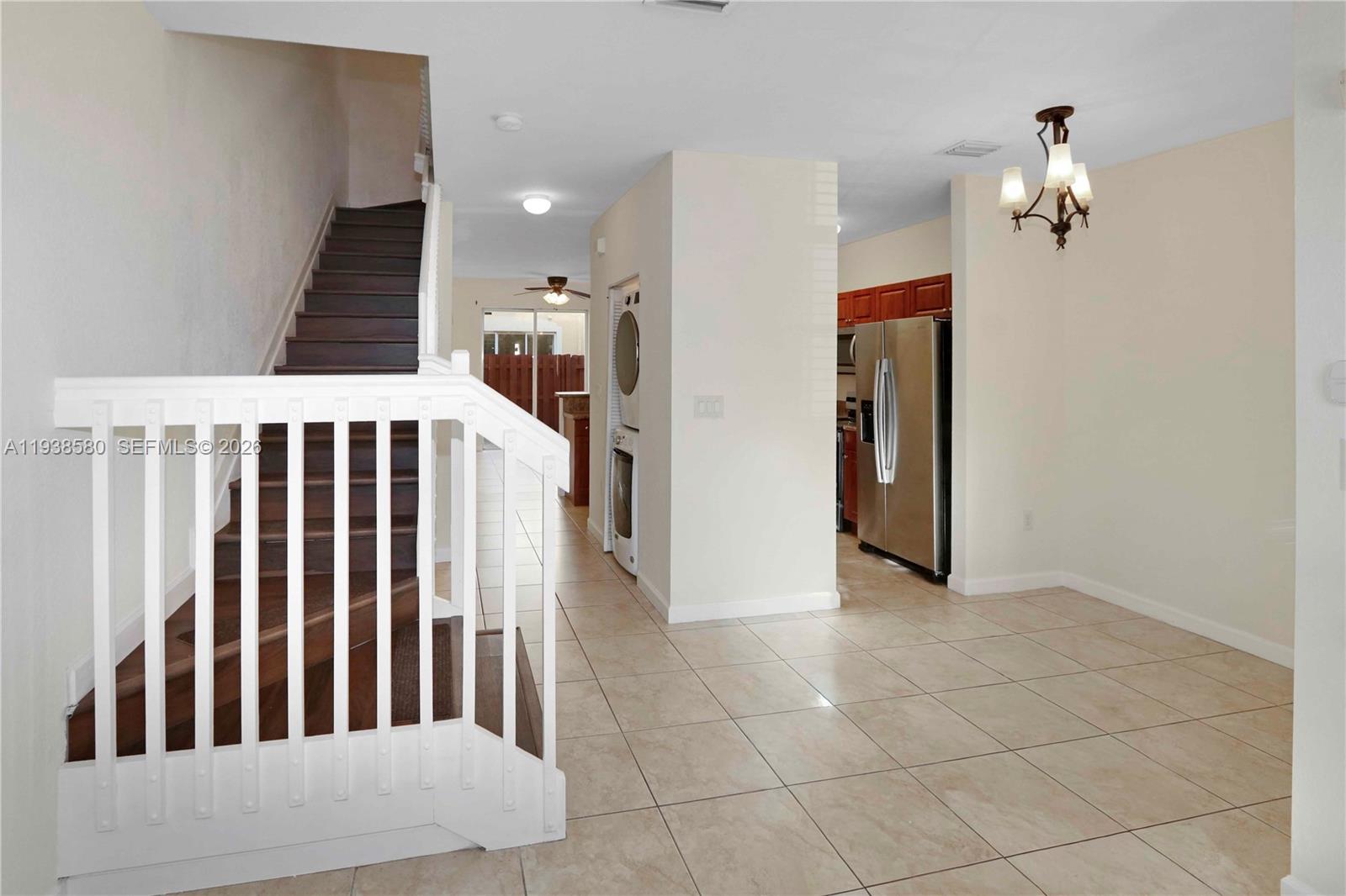 9219 Southwest 227th Street, Unit 9 Cutler Bay, FL 33190 - Photo 12 of 42 a view of a hallway with windows and stairs