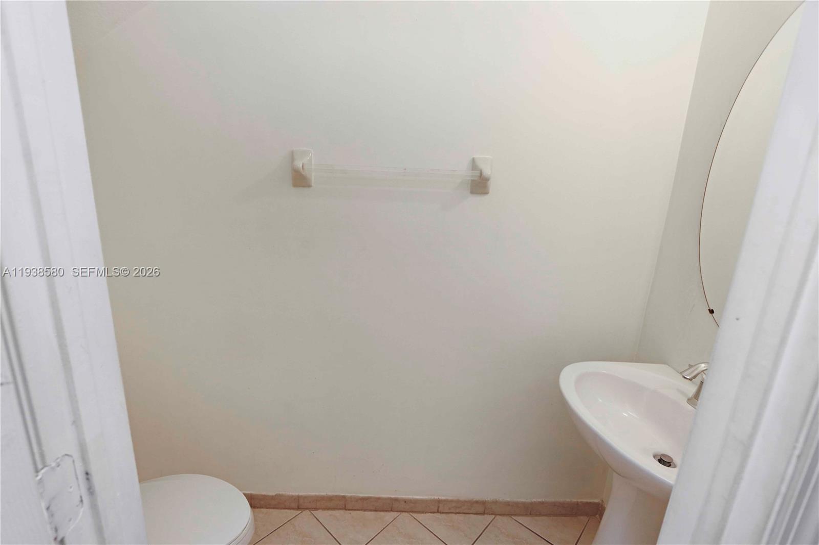 9219 Southwest 227th Street, Unit 9 Cutler Bay, FL 33190 - Photo 17 of 36 a bathroom with a toilet