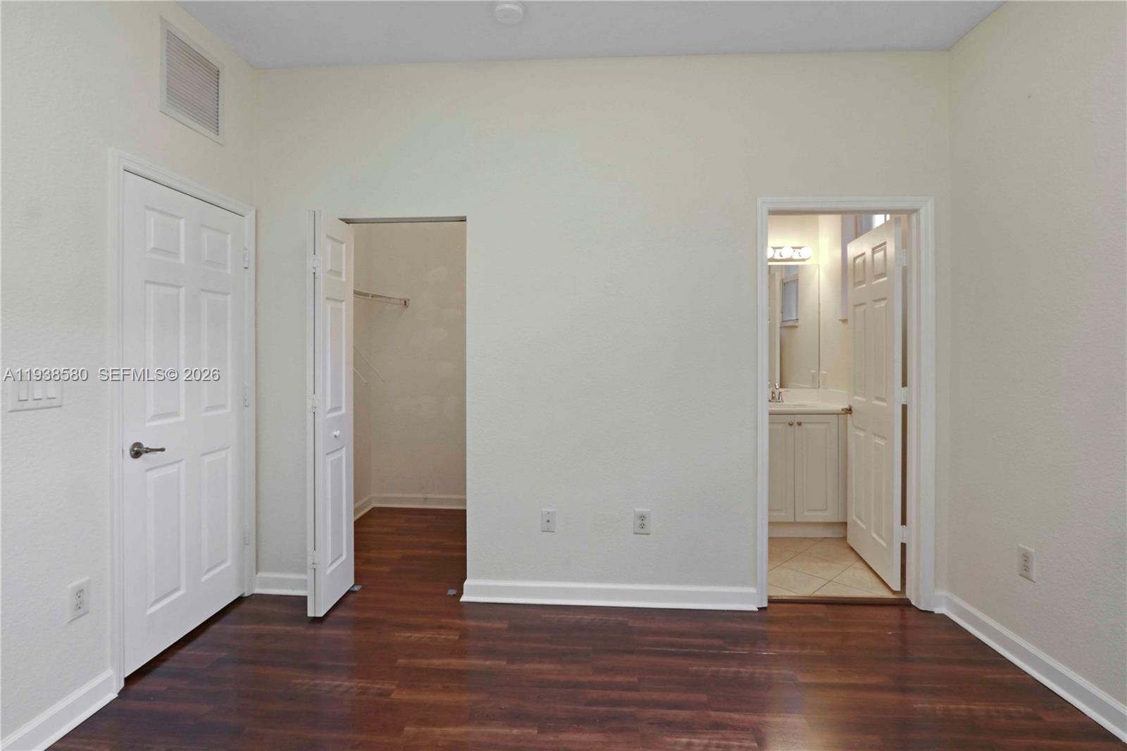 9219 Southwest 227th Street, Unit 9 Cutler Bay, FL 33190 - Photo 29 of 42 an empty room with wooden floor & windows
