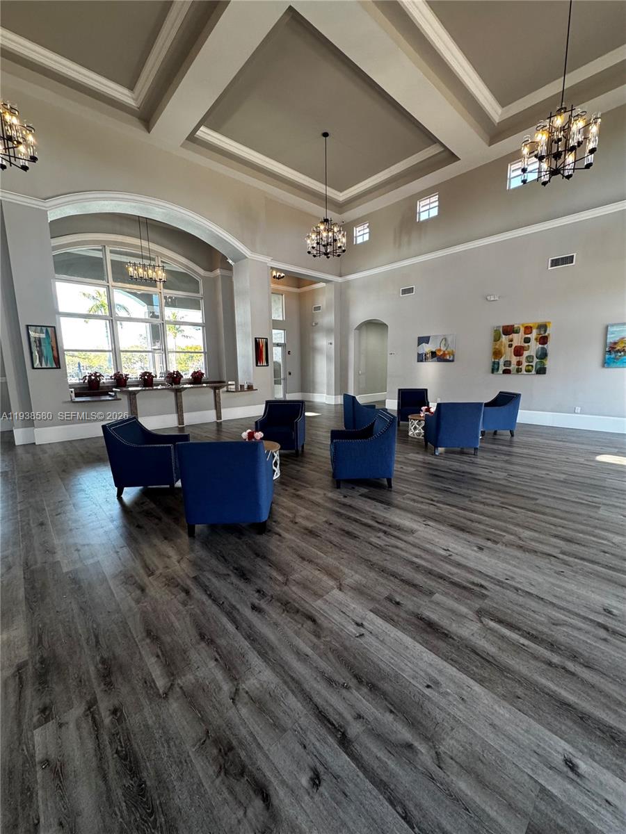 9219 Southwest 227th Street, Unit 9 Cutler Bay, FL 33190 - Photo 40 of 42 a living room with couches and kitchen view with wooden floor