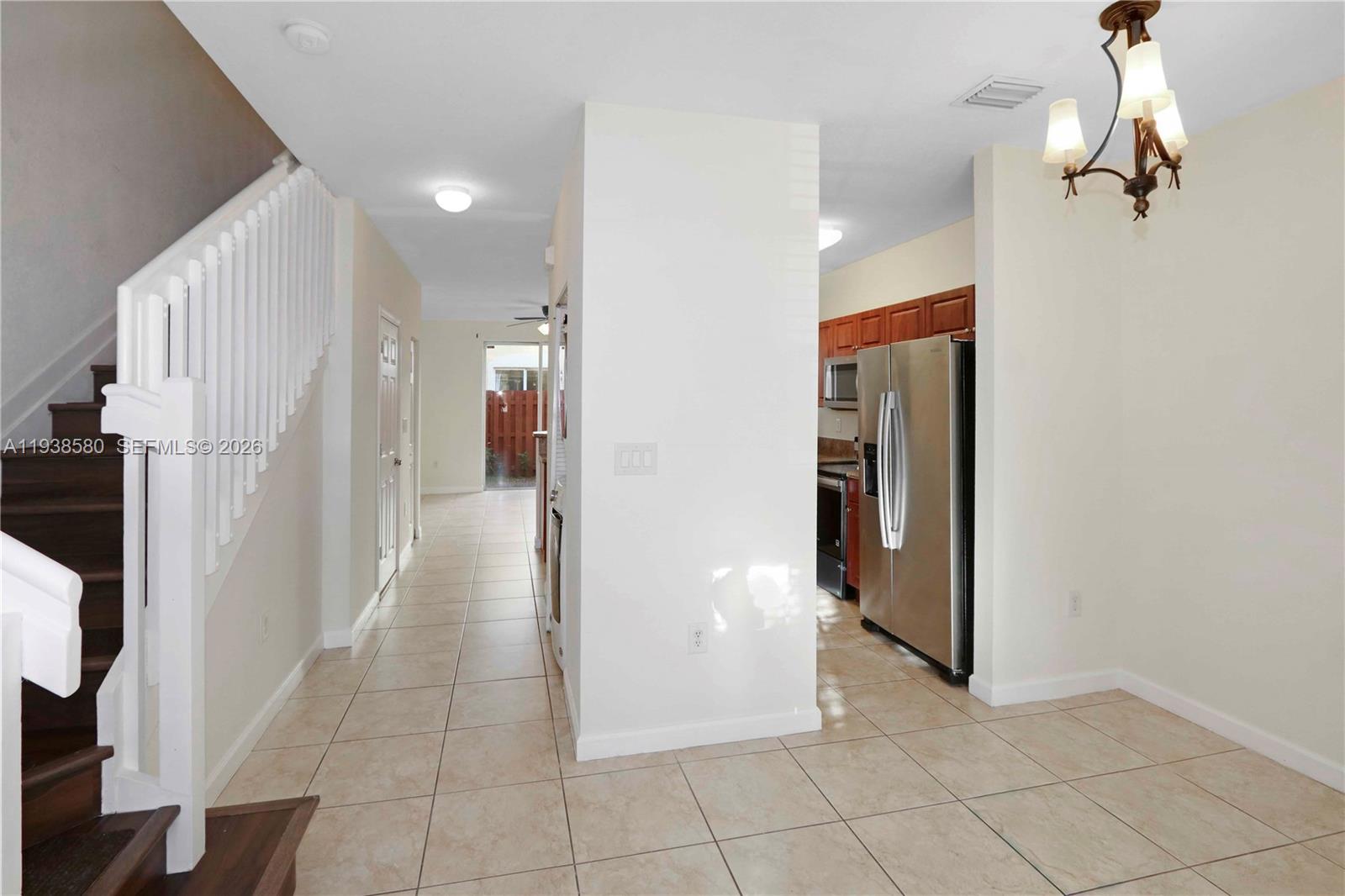 9219 Southwest 227th Street, Unit 9 Cutler Bay, FL 33190 - Photo 10 of 42 a view of a hallway with wooden shelves