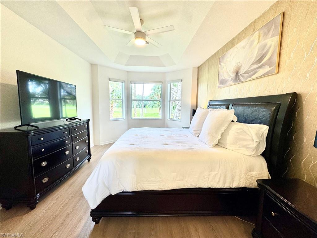 1905 Par Drive Naples, FL 34120 - Photo 12 of 30 a bedroom with a bed and a flat tv screen on dresser