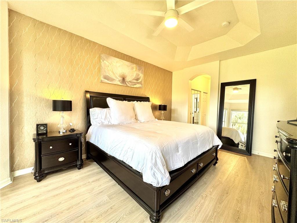 1905 Par Drive Naples, FL 34120 - Photo 13 of 30 a spacious bedroom with a bed and wooden floor