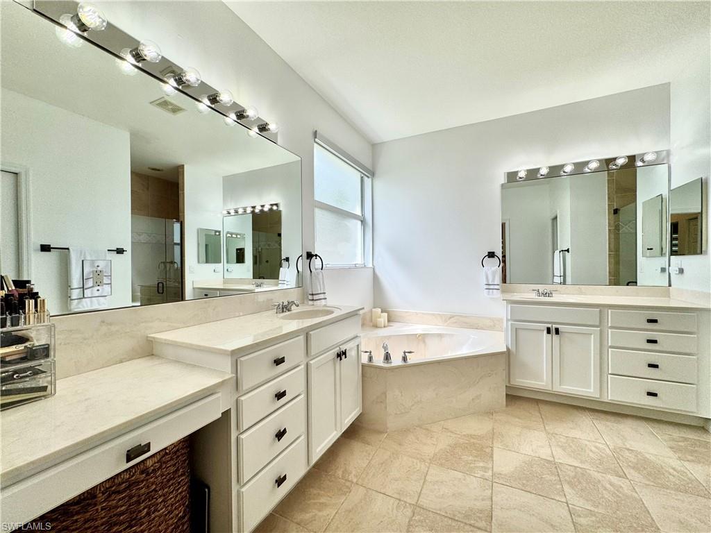 1905 Par Drive Naples, FL 34120 - Photo 14 of 30 a spacious bathroom with a granite countertop sink mirror and bathtub