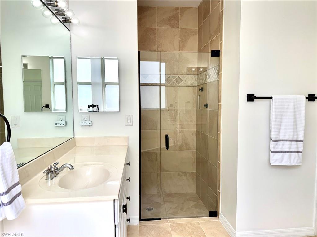 1905 Par Drive Naples, FL 34120 - Photo 15 of 30 a bathroom with a sink and a shower