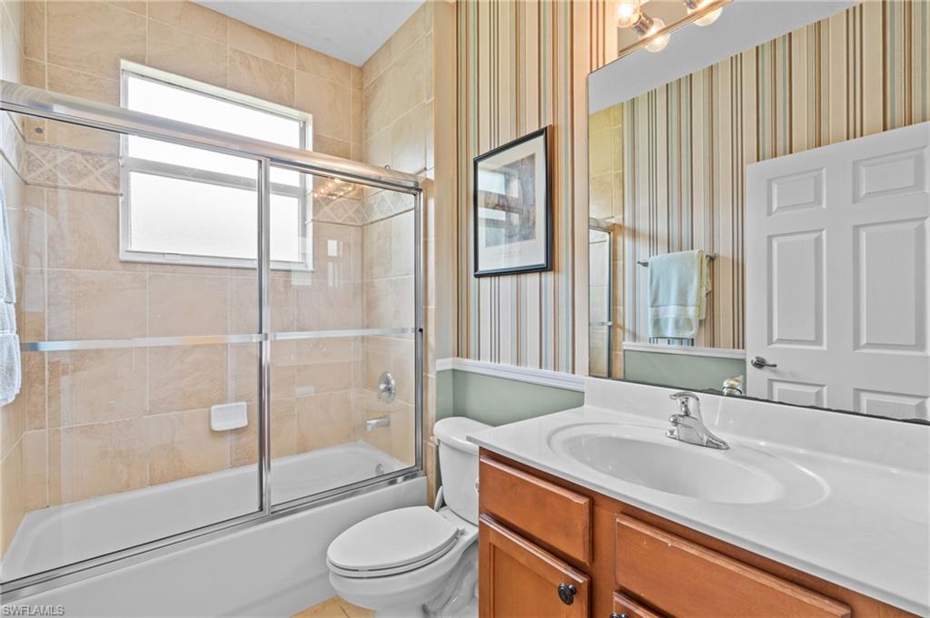 1905 Par Drive Naples, FL 34120 - Photo 18 of 30 a bathroom with a sink a toilet and shower