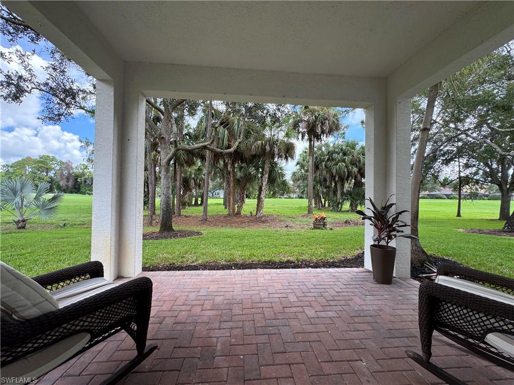 1905 Par Drive Naples, FL 34120 - Photo 22 of 30 a front view of a house with a yard table and chairs