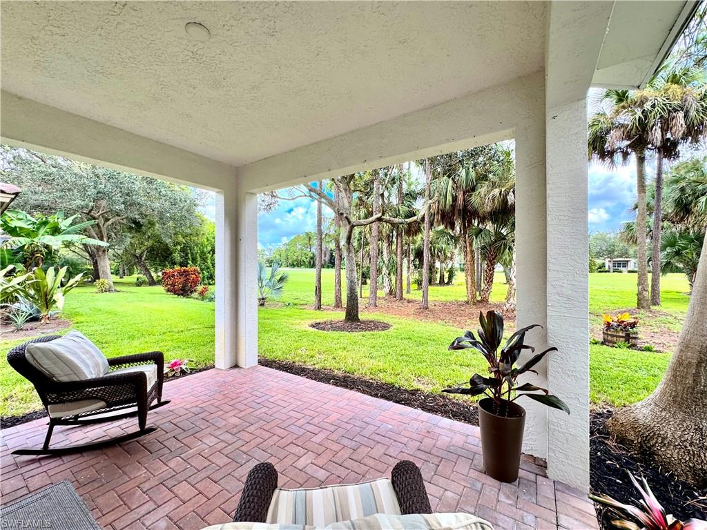 1905 Par Drive Naples, FL 34120 - Photo 23 of 30 a patio with garden area and outdoor seating