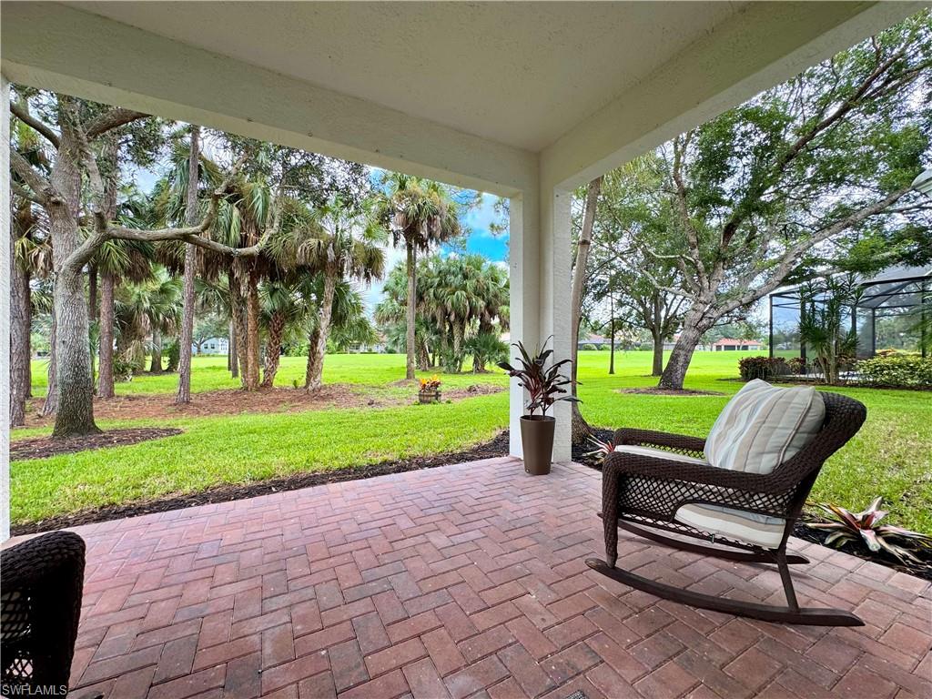 1905 Par Drive Naples, FL 34120 - Photo 24 of 30 a view of a park with bench and trees in the background