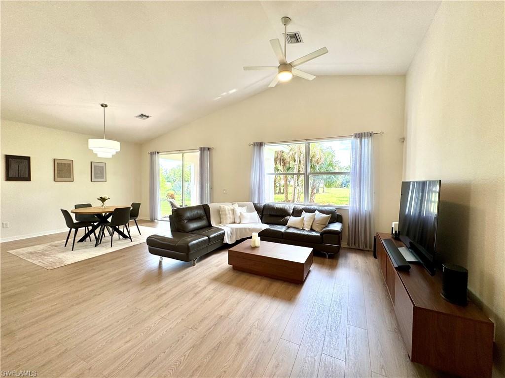 1905 Par Drive Naples, FL 34120 - Photo 4 of 30 a living room with furniture flat screen tv and hard wood flooring