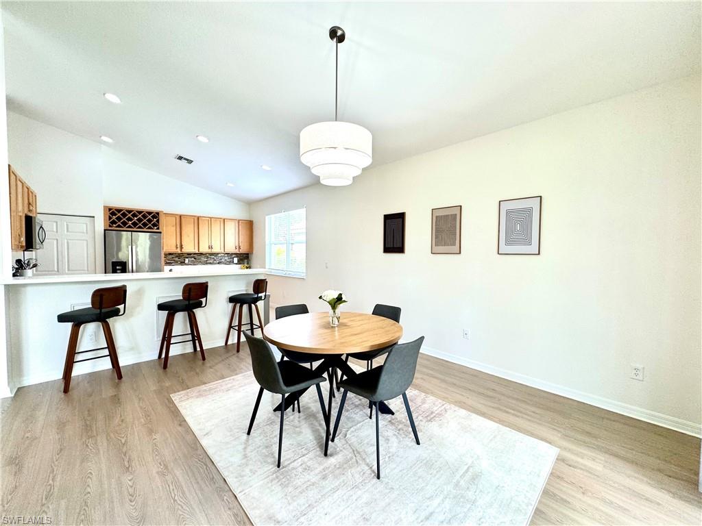1905 Par Drive Naples, FL 34120 - Photo 8 of 30 a view of a dining room with furniture and wooden floor