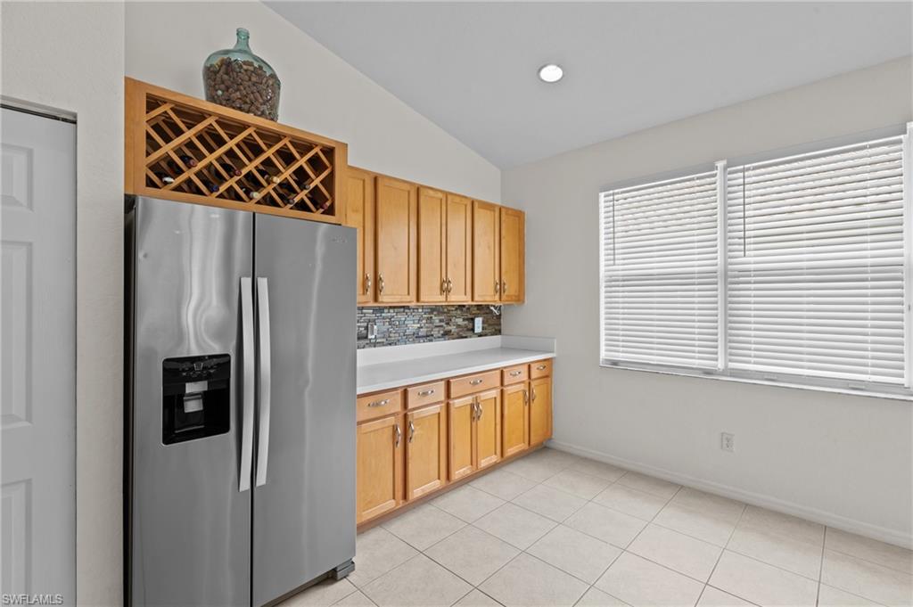 1905 Par Drive Naples, FL 34120 - Photo 10 of 30 a kitchen with stainless steel appliances granite countertop a refrigerator and a sink