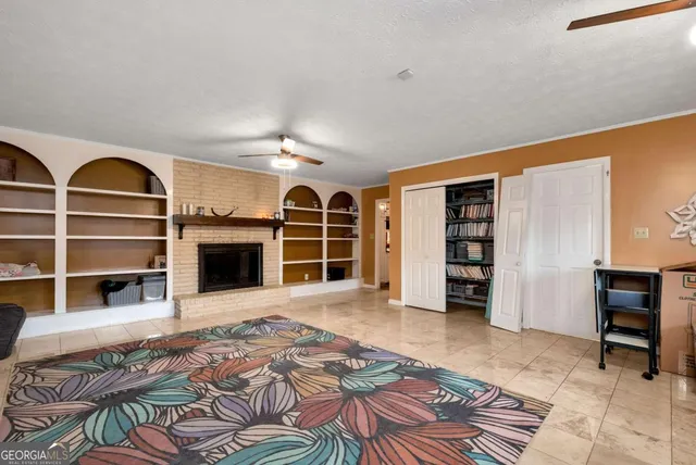 a kitchen with sink cabinets and flat screen tv