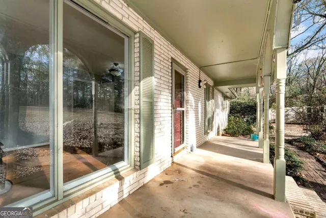 a view of swimming pool with a yard and wooden fence