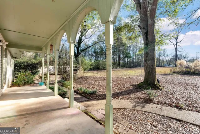 a view of a yard with wooden fence
