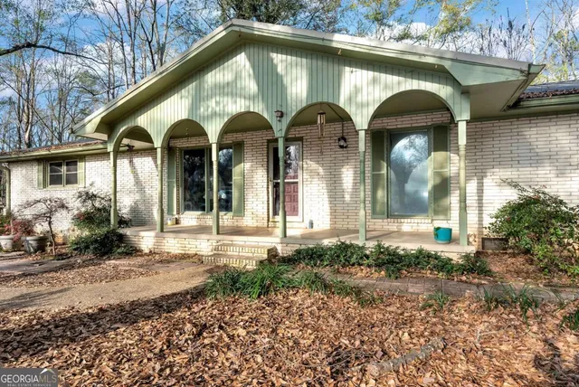 a view of a backyard with large trees