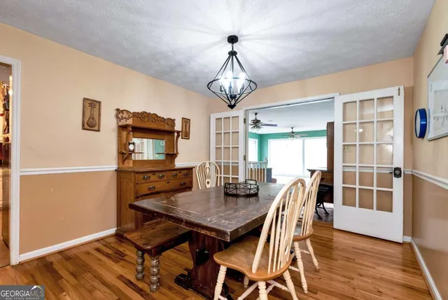 a kitchen with granite countertop a sink window and white cabinets