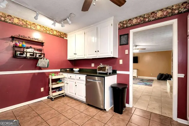 a spacious bedroom with a bed and a television