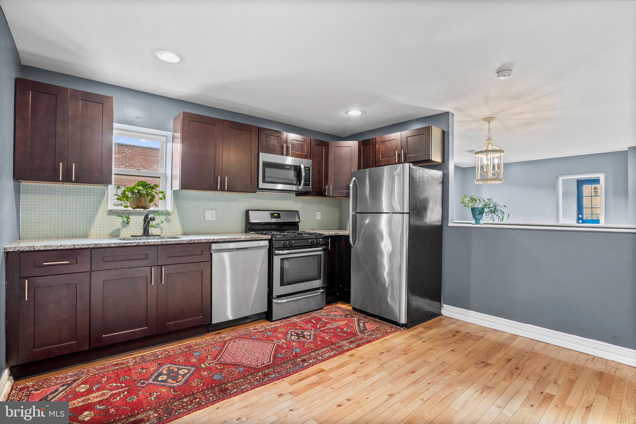 2024 South 12th Street, Unit 2 Philadelphia, PA 19148 - Photo 1 of 21 a kitchen with granite countertop stainless steel appliances a refrigerator sink and microwave