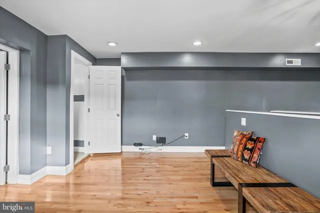 a view of room with furniture and wooden floor