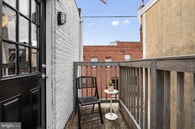 a view of a balcony with furniture and floor to ceiling window
