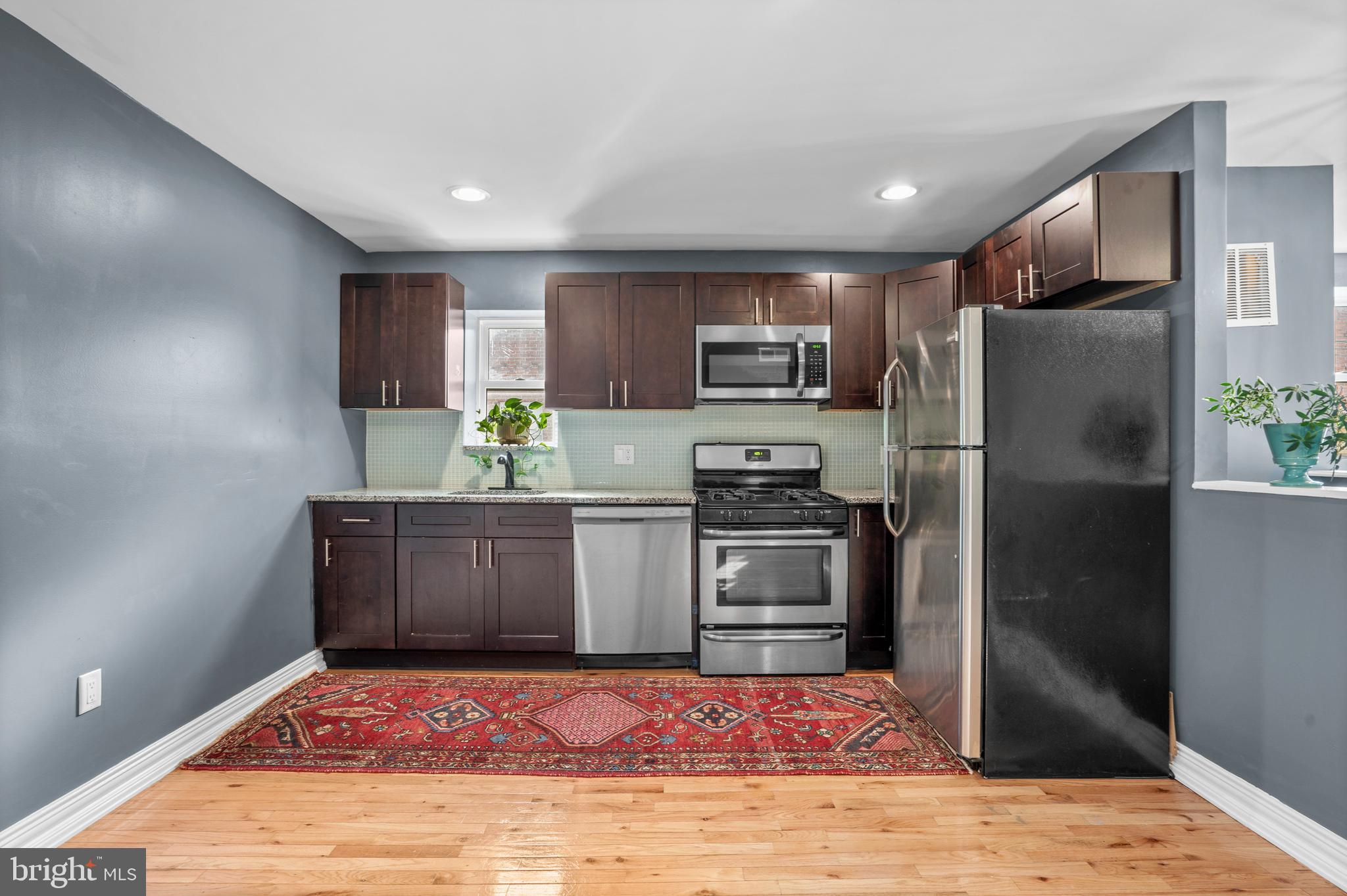 2024 South 12th Street, Unit 2 Philadelphia, PA 19148 - Photo 2 of 21 a kitchen with stainless steel appliances kitchen island granite countertop a refrigerator and a sink