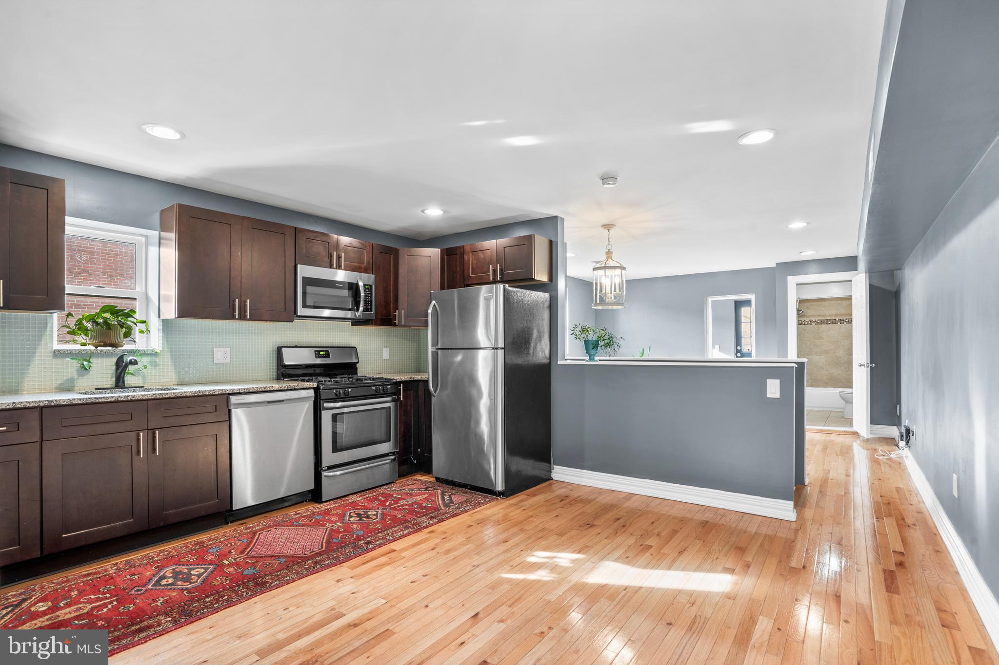 2024 South 12th Street, Unit 2 Philadelphia, PA 19148 - Photo 3 of 21 a kitchen with refrigerator cabinets and wooden floor