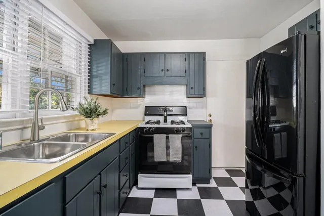 a kitchen with a sink stove and refrigerator