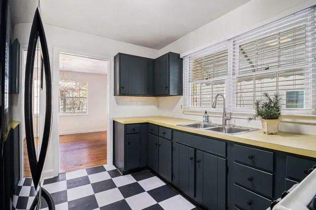 a spacious bathroom with a granite countertop sink and a mirror