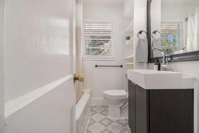 a bathroom with a sink toilet and tub
