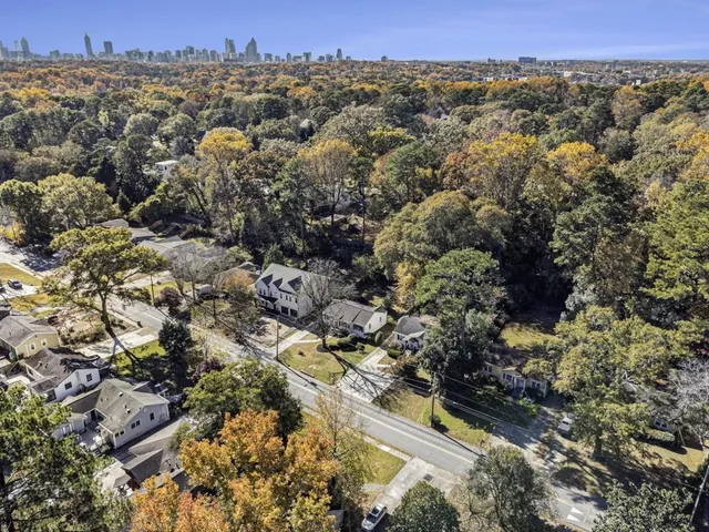 an aerial view of a houses with a yard
