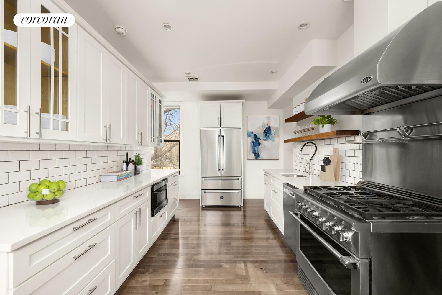 320 Macon Street, Unit 3 Brooklyn, NY 11216 - Photo 4 of 11 a kitchen with white cabinets and appliances