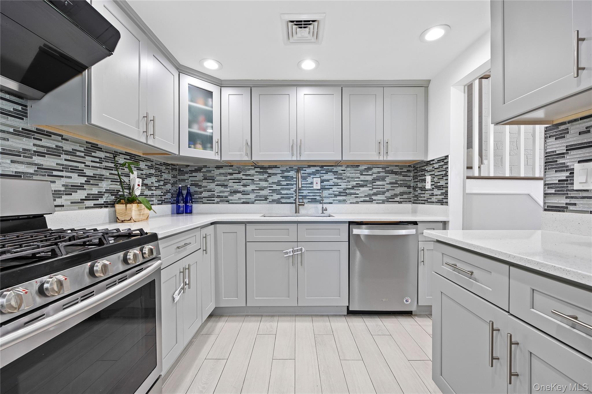 38 Oxford Road Old Bethpage, NY 11804 - Photo 12 of 23 a kitchen with kitchen island granite countertop a stove and a sink