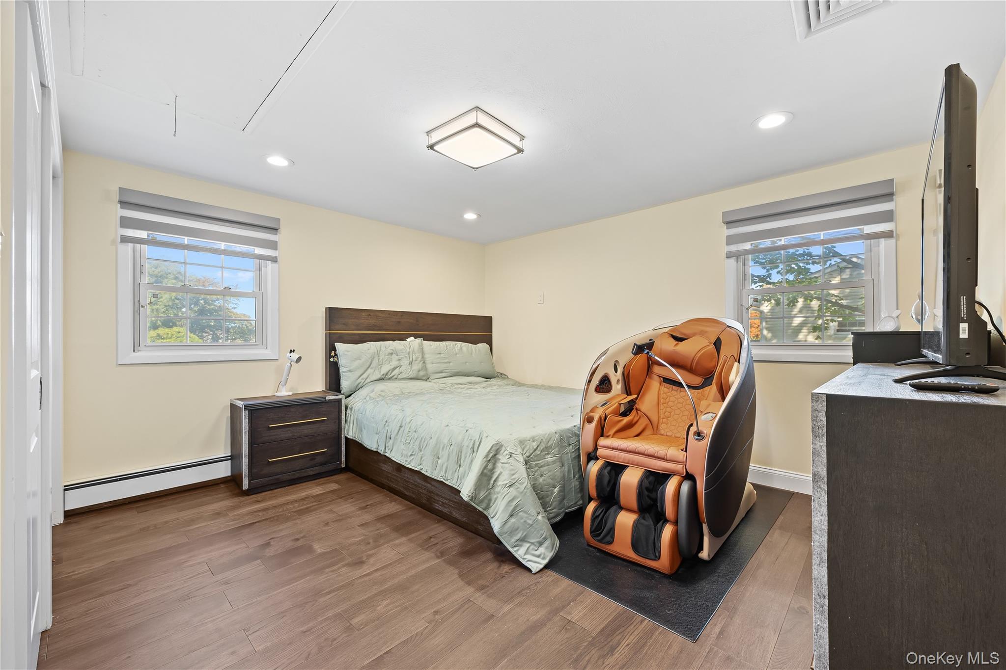 38 Oxford Road Old Bethpage, NY 11804 - Photo 15 of 23 a bedroom with a bed and wooden floor