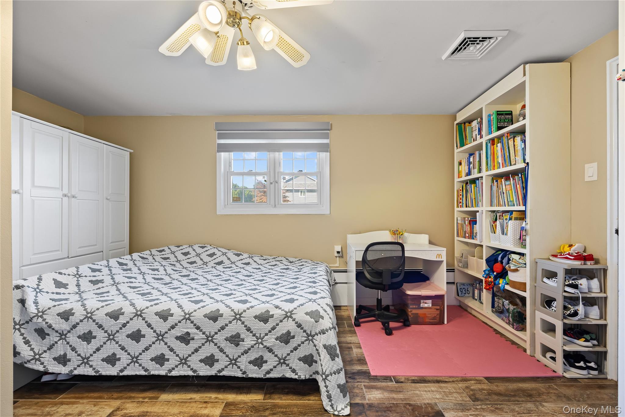 38 Oxford Road Old Bethpage, NY 11804 - Photo 16 of 23 a bedroom with a bed and a book shelf