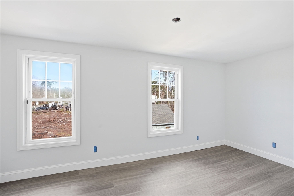 357 Wareham Street Middleboro, MA 02346 - Photo 25 of 42 an empty room with wooden floor and windows