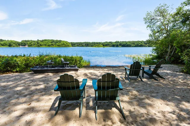a view of a lake with houses in the back