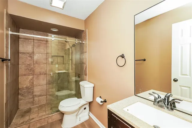 a bathroom with a sink toilet and shower