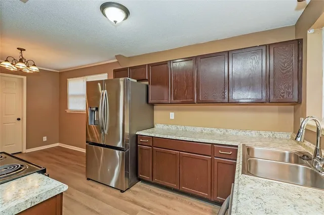 a kitchen with granite countertop stainless steel appliances and wooden cabinets