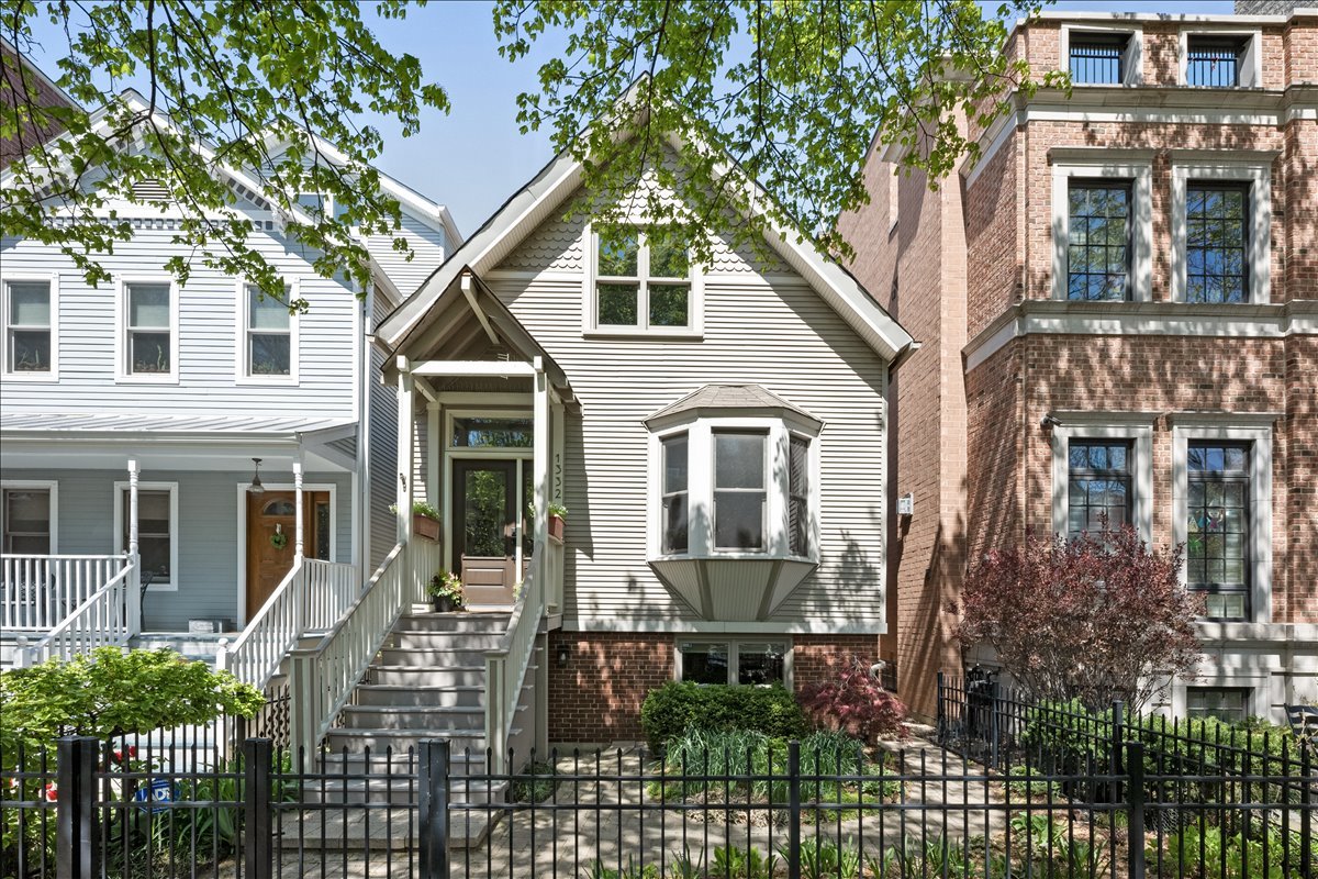 1332 West School Street Chicago, IL 60657 - Photo 1 of 45 a front view of a house with a garden