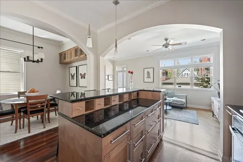a kitchen with granite countertop a sink and a refrigerator