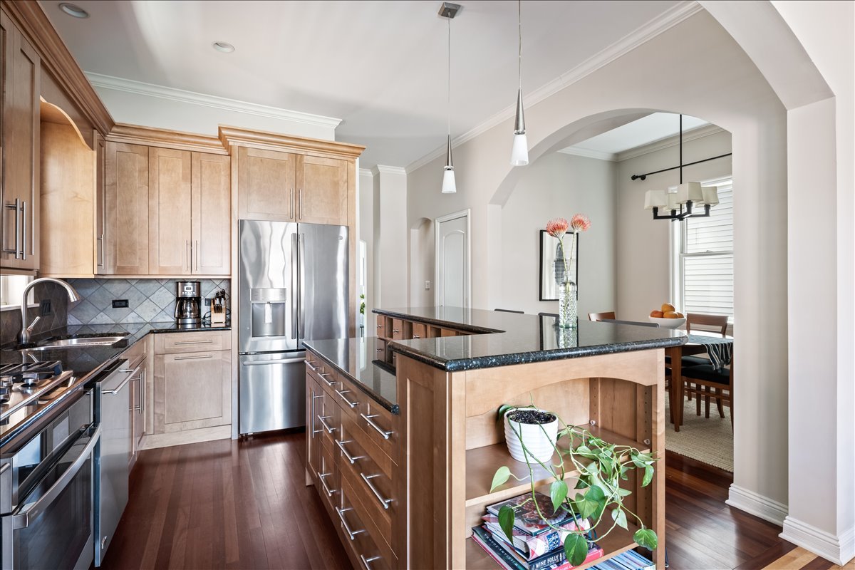 1332 West School Street Chicago, IL 60657 - Photo 14 of 45 a kitchen with stainless steel appliances granite countertop a refrigerator a sink a stove and white cabinets with wooden floor