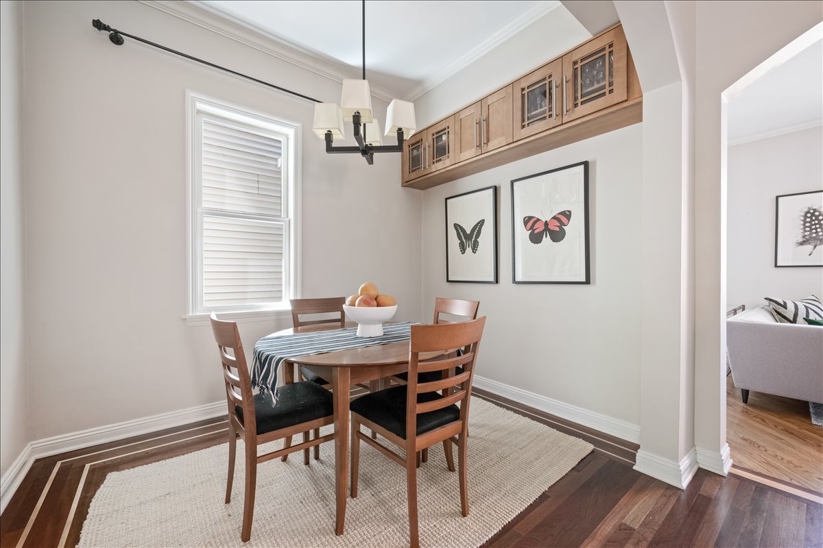 1332 West School Street Chicago, IL 60657 - Photo 16 of 45 a view of a dining room with furniture wooden floor and a chandelier