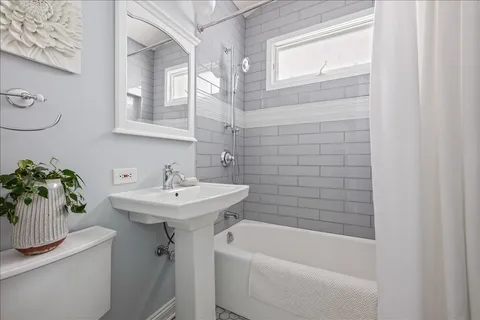 a bathroom with a sink a mirror and a bathtub
